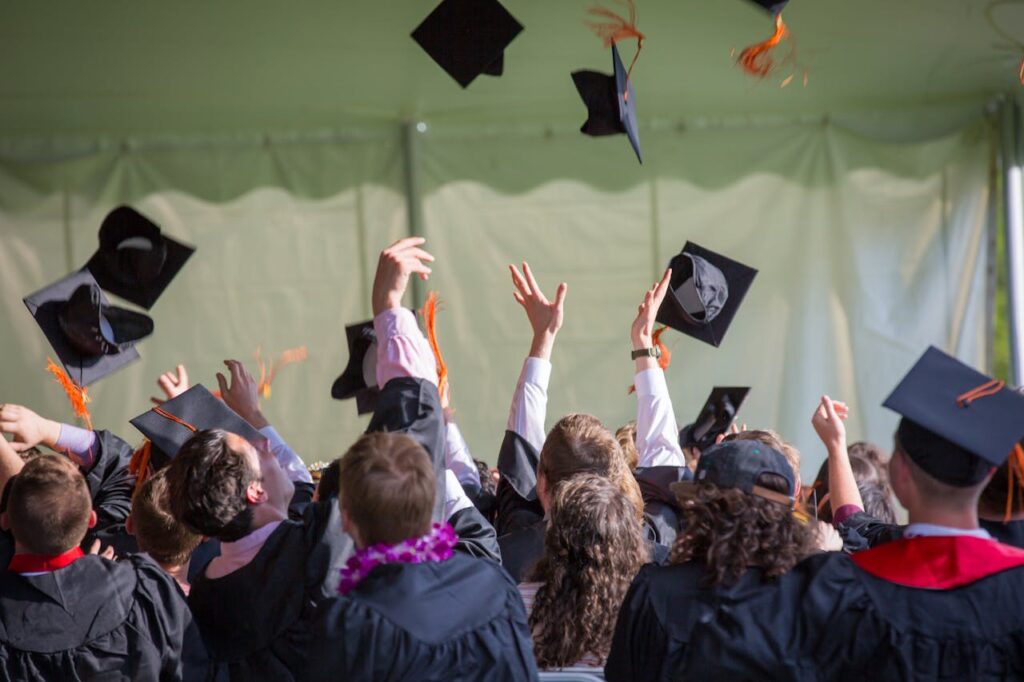 pexels photo 1205651 Group of graduates celebrating by tossing caps into the air during a graduation ceremony.